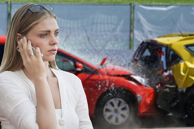 After a car accident, a girl on a cell phone making a call.