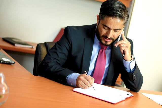 A lawyer in office on phone